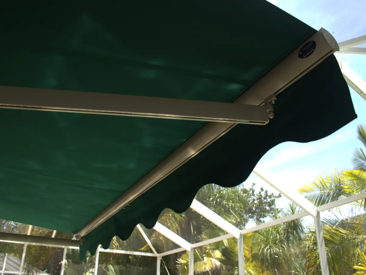 Underside of an extended awning, folding arm and motor housing in view