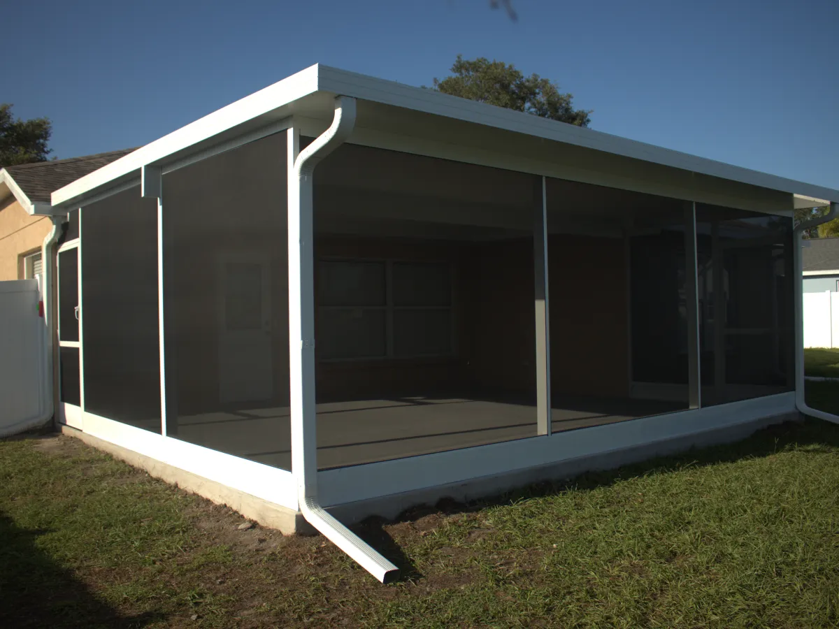 Screen room with a solid insulated roof panel, gutter running down the corner post